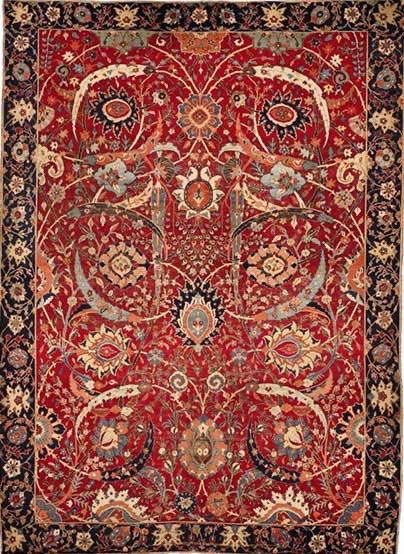 Antique Iranian carpet displayed in museum setting