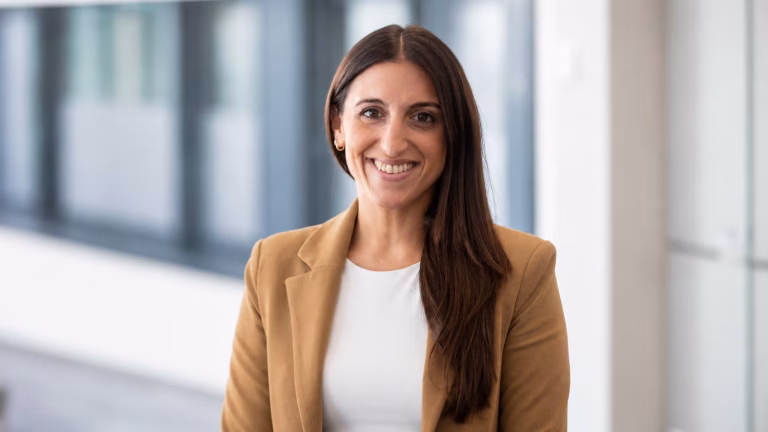 Professional textile industry banner featuring Jaime Griggs of Hohenstein with refined blue background and quote about proof-based compliance in the apparel industry.